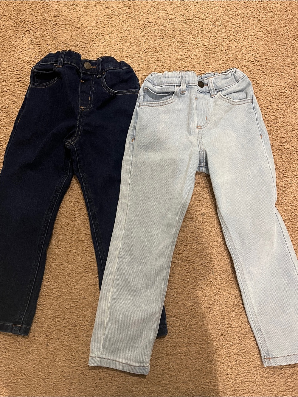 Two pairs of jeans adjustable waist. No tags but never worn. Son grew to fast
